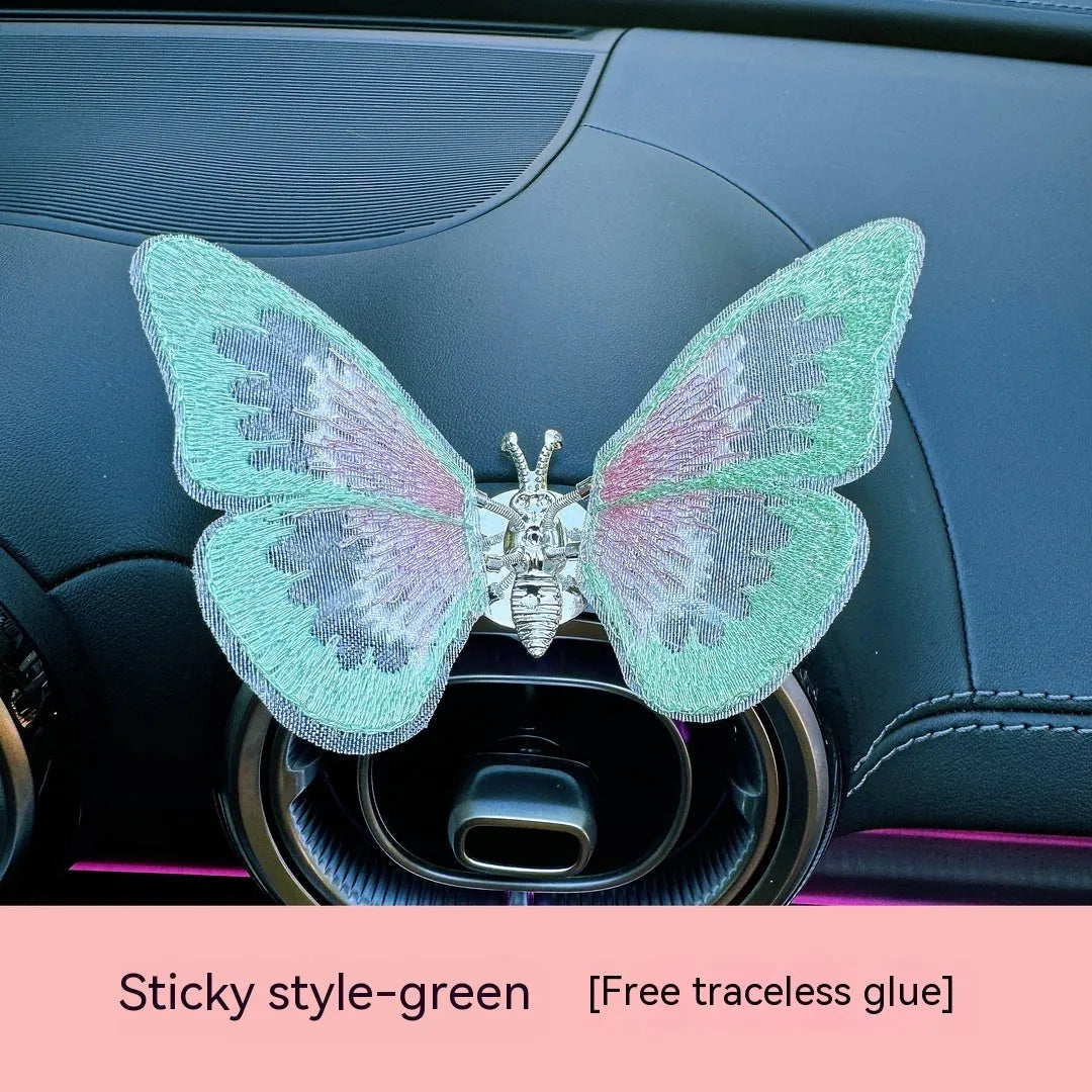 Moving embroidery butterfly decoration on car centre console air vent in pink fabric