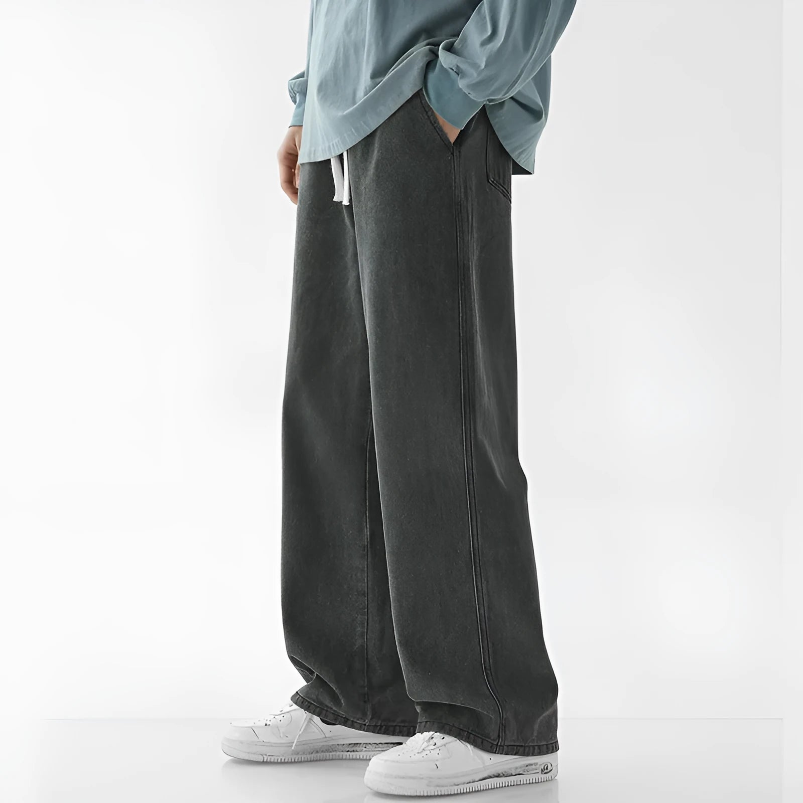 Mens fashion casual loose straight cotton denim jeans in retro light blue colour, full-length view