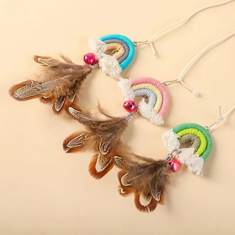 Cat door swing toy with colourful feathers on elastic cord attached by sticky buckle clamp