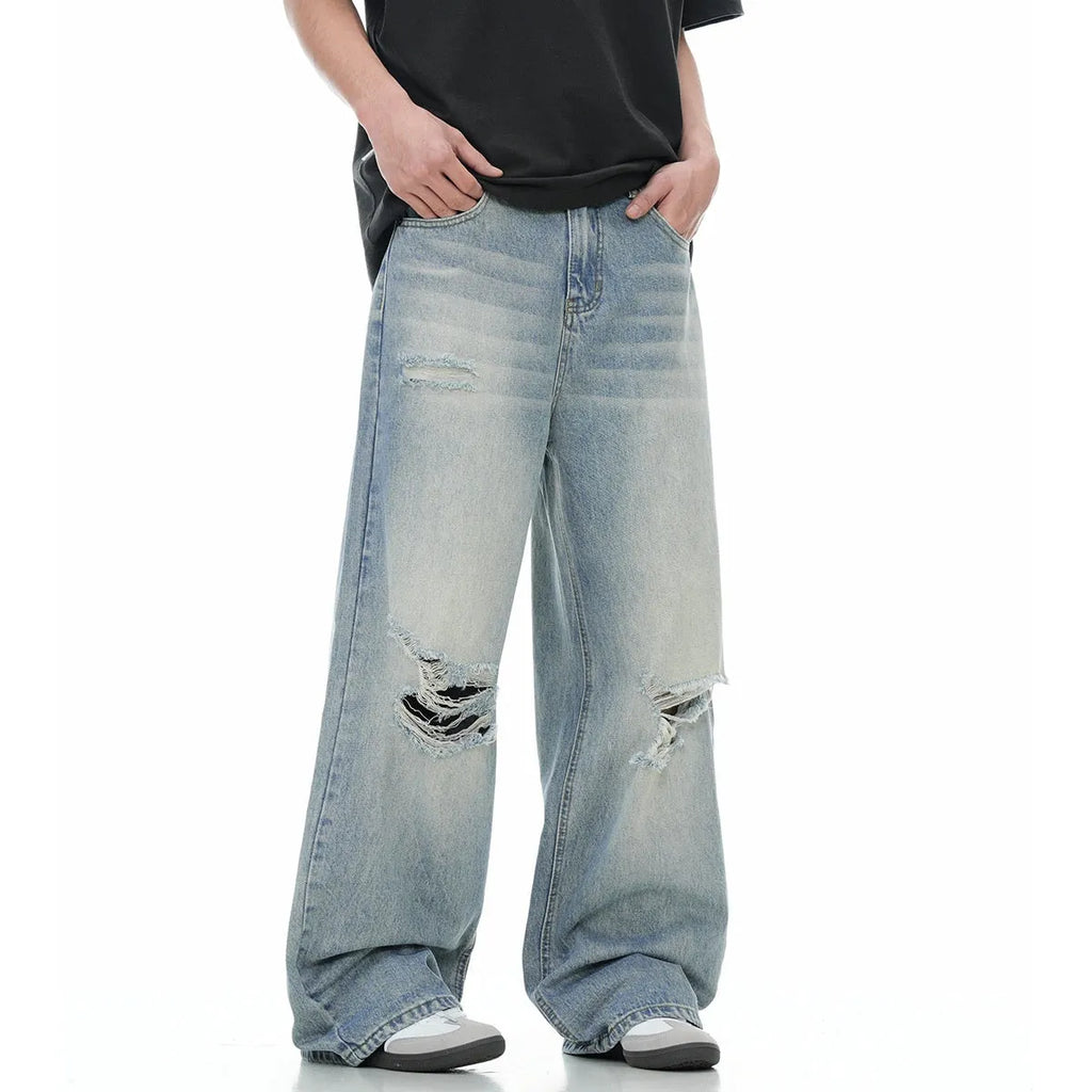 Denim blue straight-leg jeans with ripped details and zip fly closure