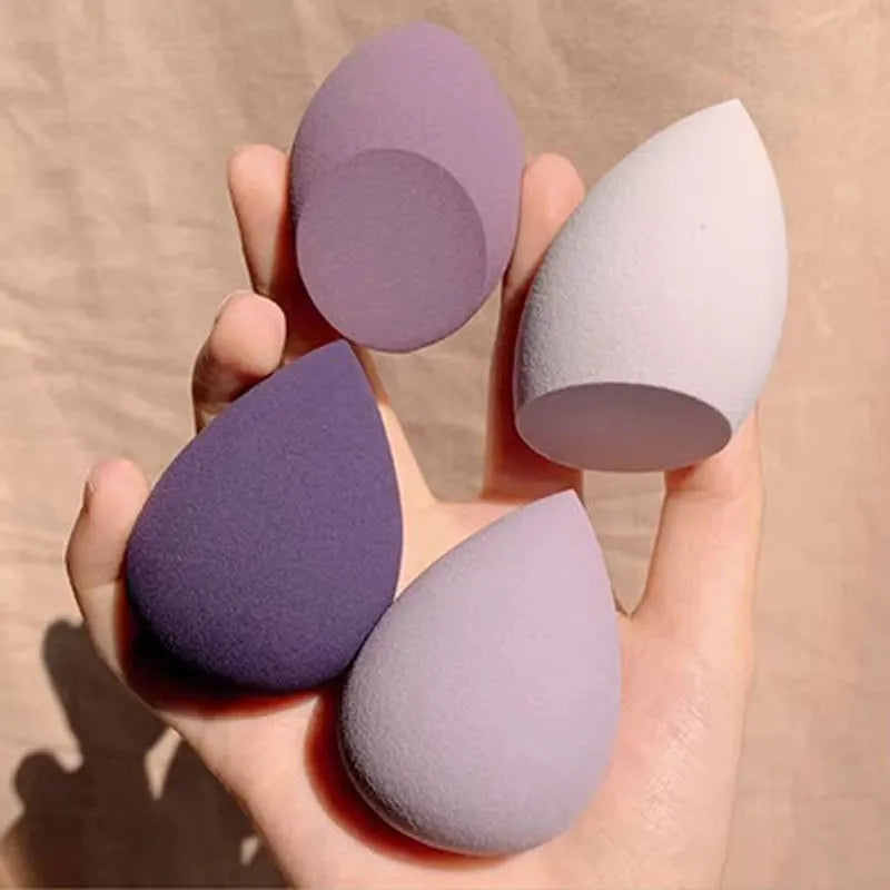 Assorted makeup sponges in seven shapes including pear and peach heart designs, 60x42mm, non-latex material