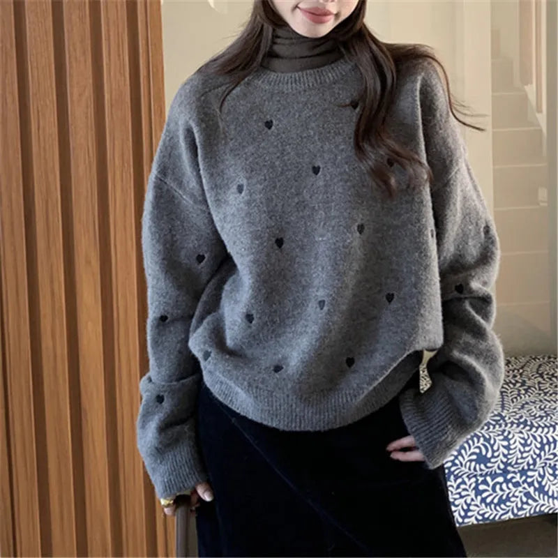 Women's loose-fit acrylic pullover sweater with embroidered heart detail on the front.