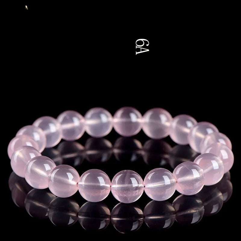 Pink crystal bracelet with round polished beads in natural starlight style showing size options from 6mm to 22mm diameter
