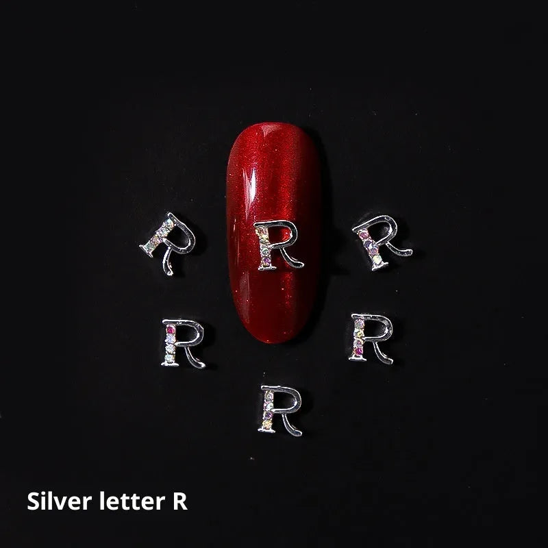 Gold alloy letter A nail ornament charm with crystal detail on a square chain base