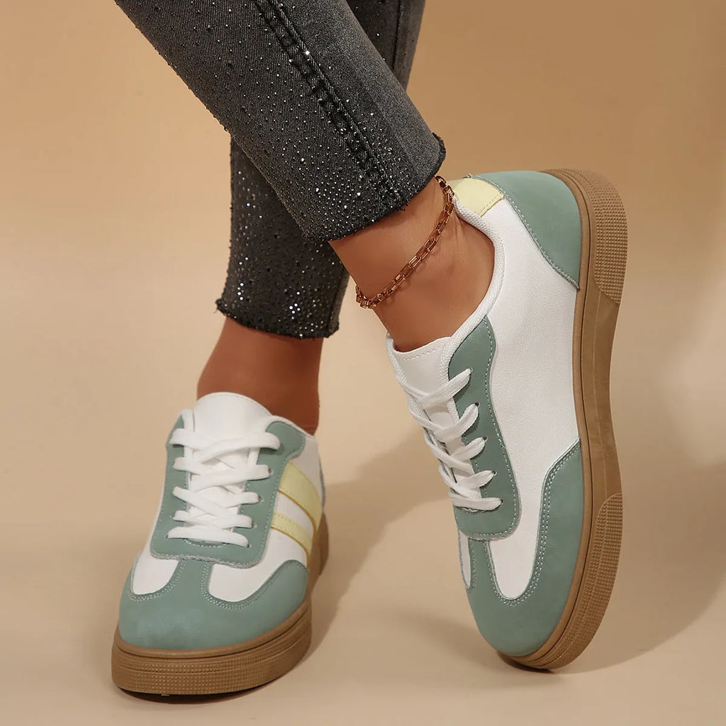 Green women's retro sports low-top shoes with cross straps and round toe on a rubber sole.