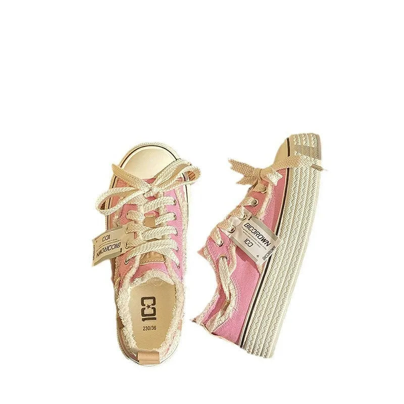 Women's low-top canvas shoes in solid colour with vulcanised rubber sole, available in beige, black, and pink.