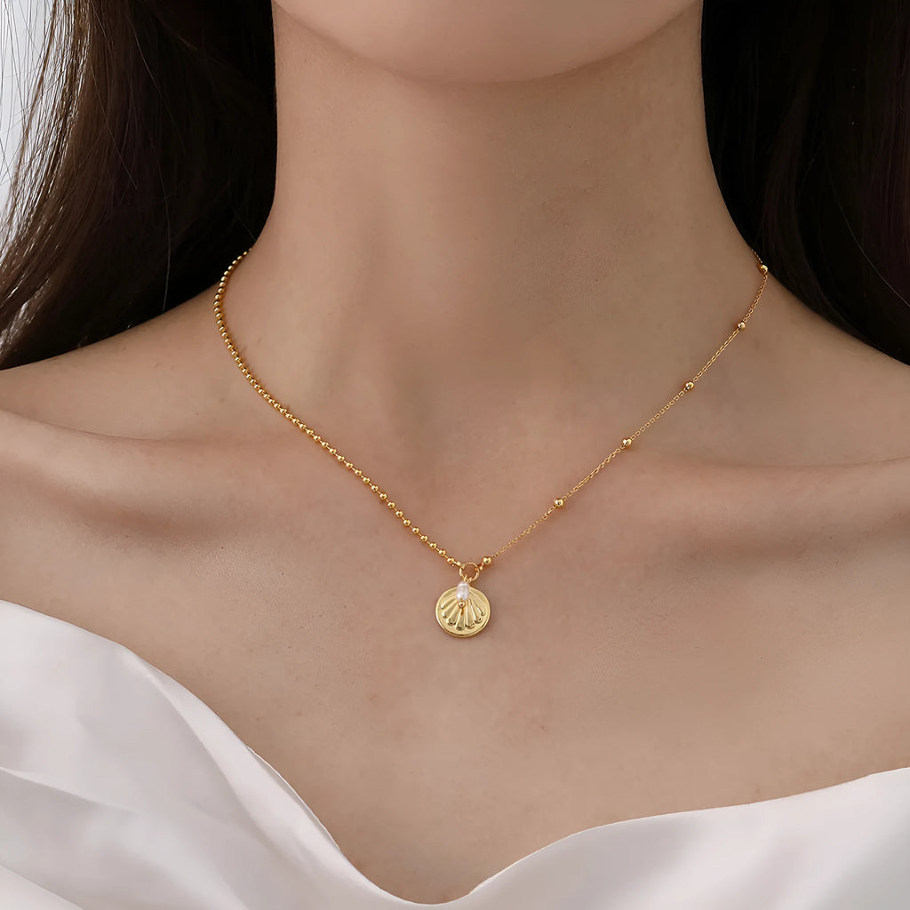 Natural pearl shell pendant necklace with adjustable copper chain on a neutral background