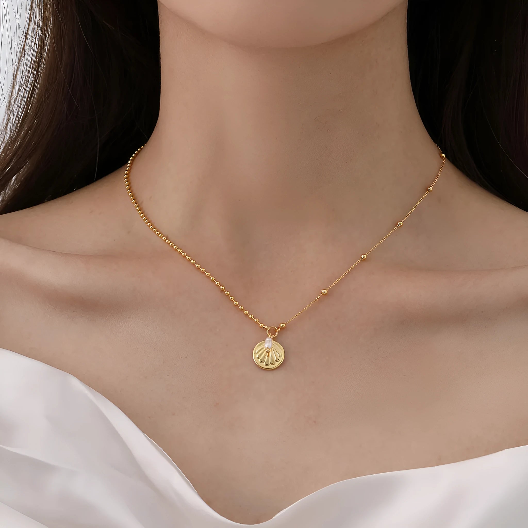 Natural pearl shell pendant necklace with adjustable copper chain on a neutral background