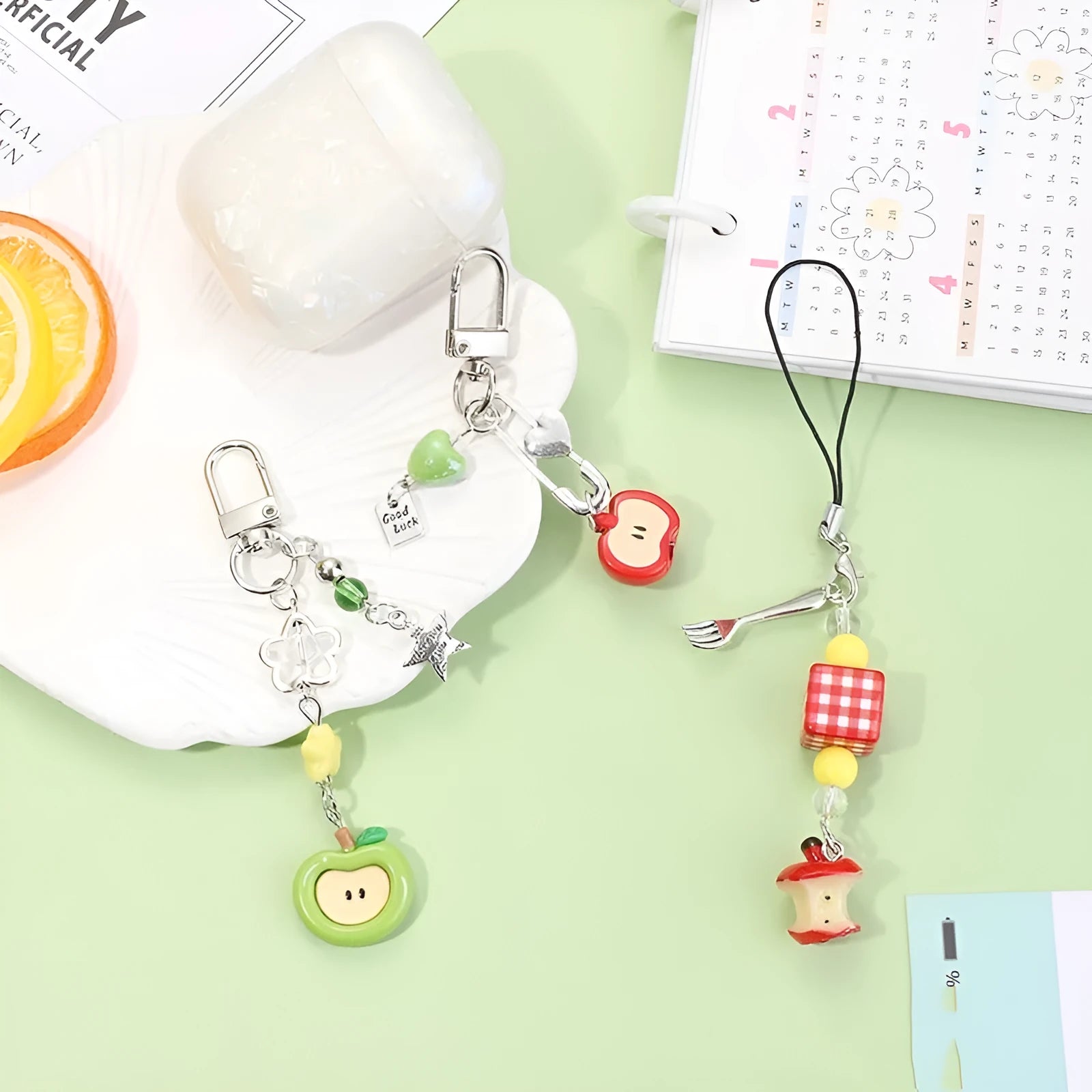 Plastic resin fruit phone charm keychain with strawberry design on white rope cord