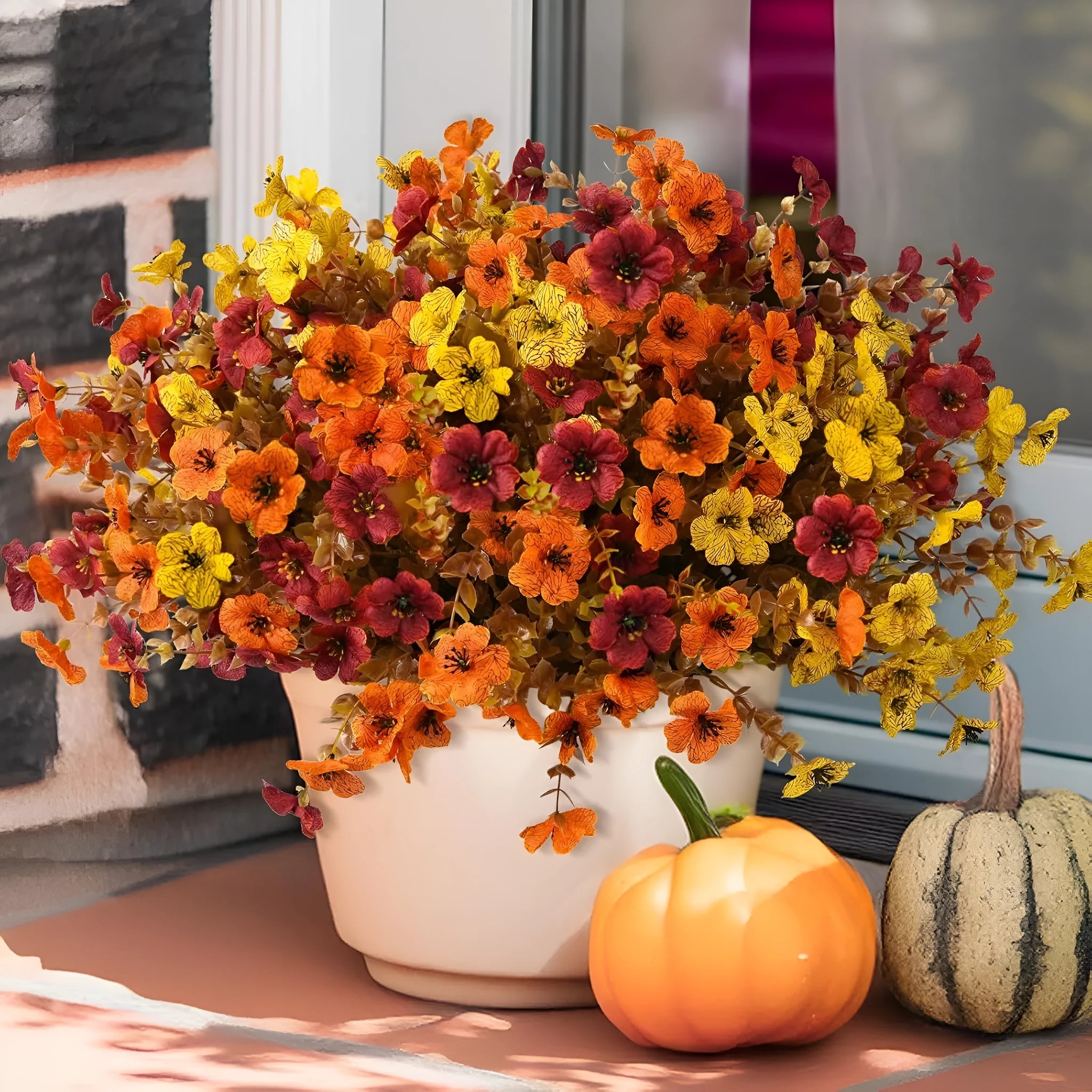 Artificial flower bouquet in autumn red, yellow, orange and orange-yellow colours for home and wedding decoration