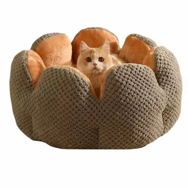 Green cactus petal shaped enclosed soft plush bed for a cat or small dog on a hardwood floor.