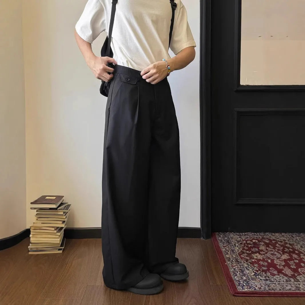 Men's straight-leg casual trousers in black with wide-leg draping silhouette on hanger