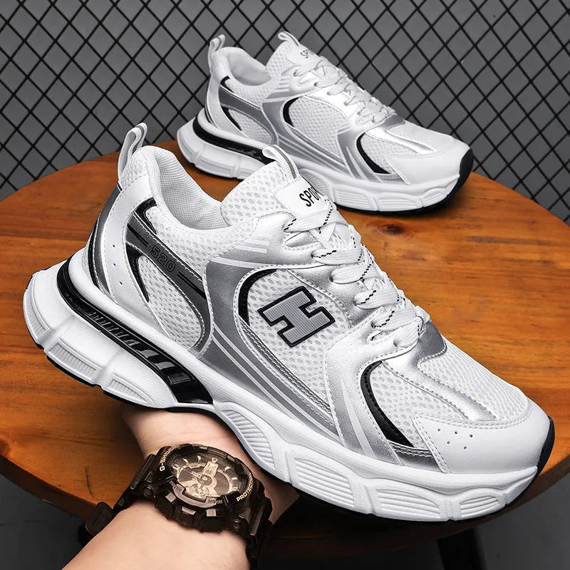 Men's white and grey mesh running shoes with a round toe and plastic sole on a plain background.