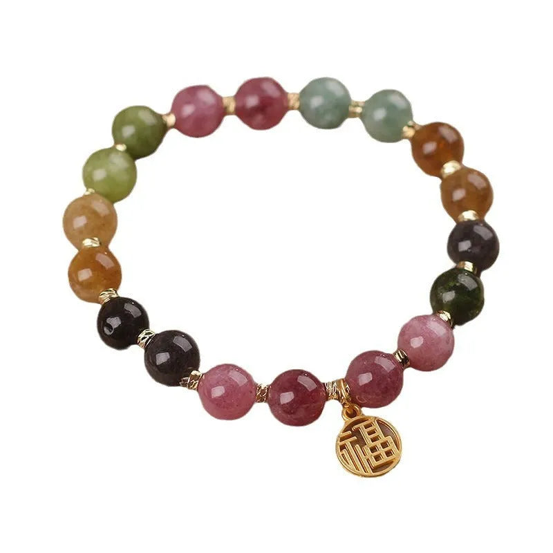 Natural colour tourmaline bracelet with floral and fu character charms on geometric electroplated chain