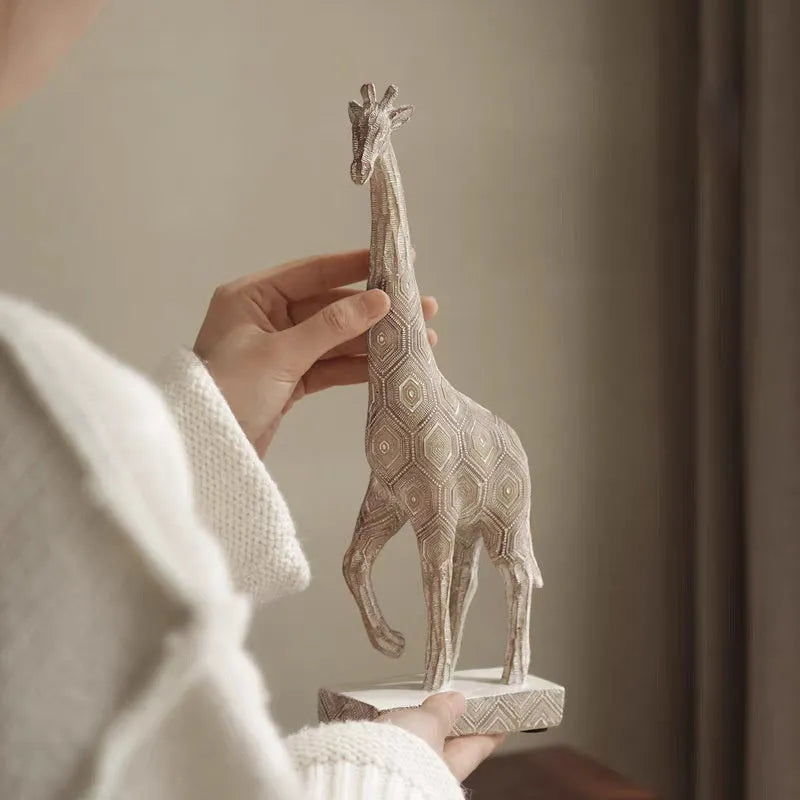 Wood colour synthetic resin giraffe ornament on a surface, showing European style and size scale.