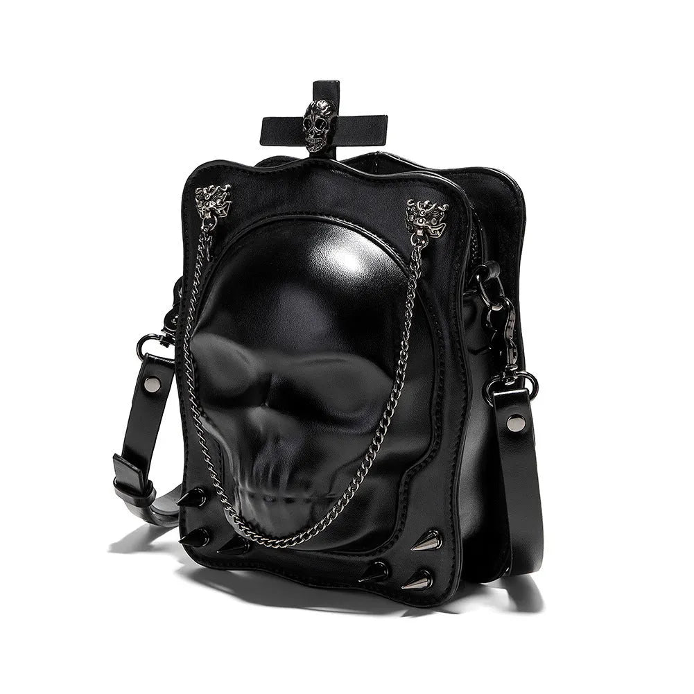 Black mini square crossbody bag with skull embroidery, decorative stitching, and metal chain details