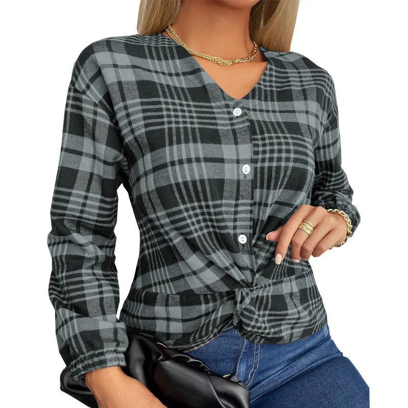Woman wearing a loose-fit purple plaid casual shirt with regular sleeves.