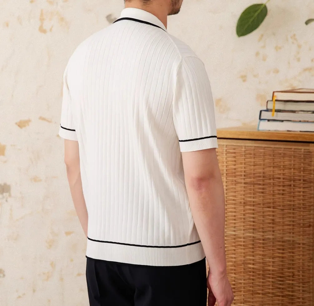 Slim-fit man's knitted polo shirt with a lapel collar and short sleeves in a black viscose blend fabric.