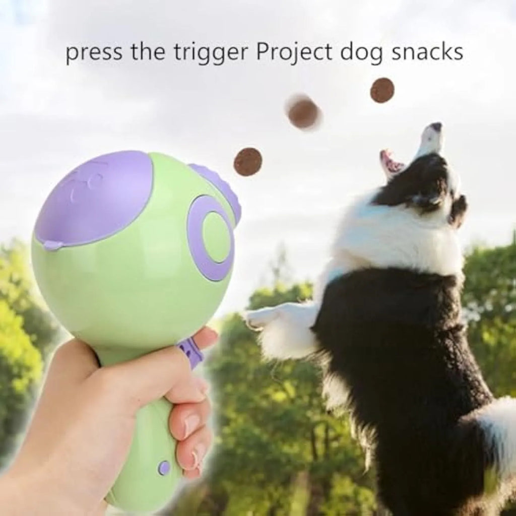 Green, orange, and pink dog treat launcher toy shown next to a measuring tape indicating 15.5 cm length.