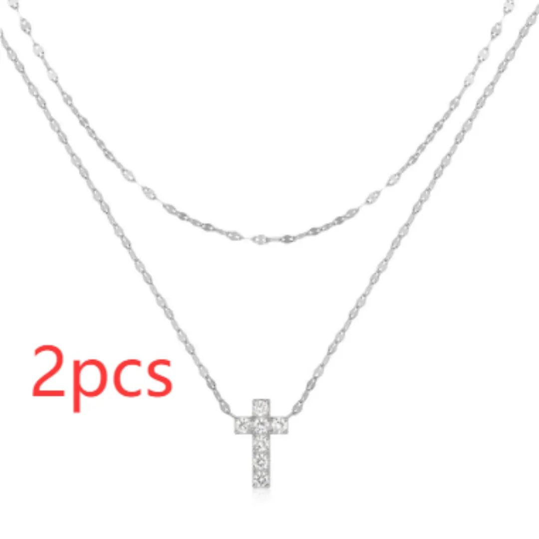 Double layer geometric twin diamond cross pendant on a sterling silver clavicle chain.