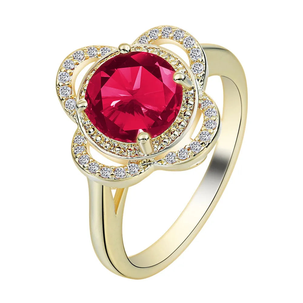 Copper zircon ring with a fruit-shaped design on a finger.