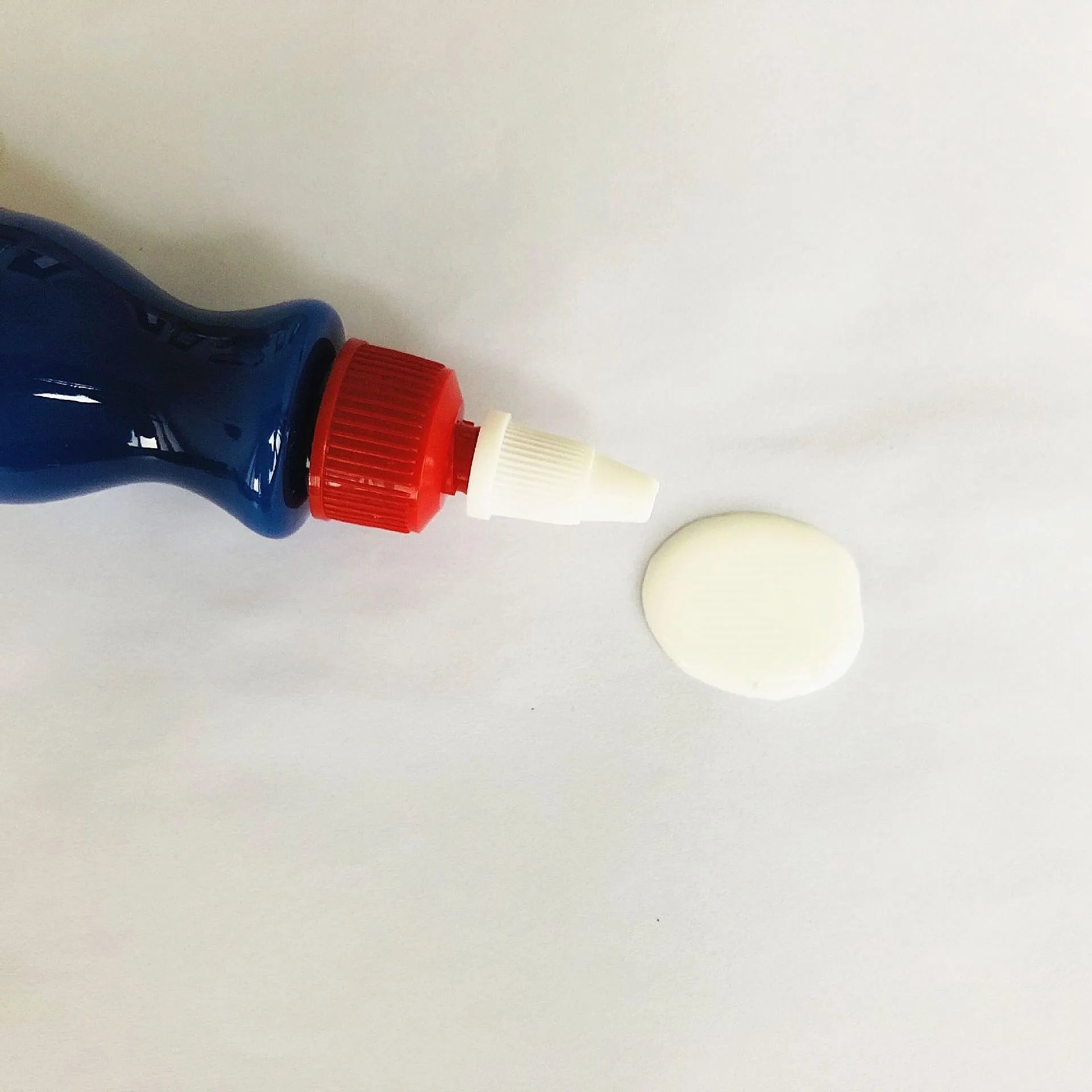 Small blue container of car scratch repair agent with sponge applicator for vehicle paint touch-ups