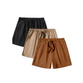 Three pairs of men's solid colour drawstring shorts in black, khaki and light brown laid flat