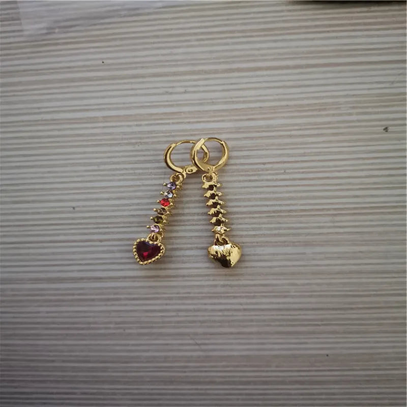 A pair of women's heart-shaped fashion earrings in a gold or silver alloy metal finish.