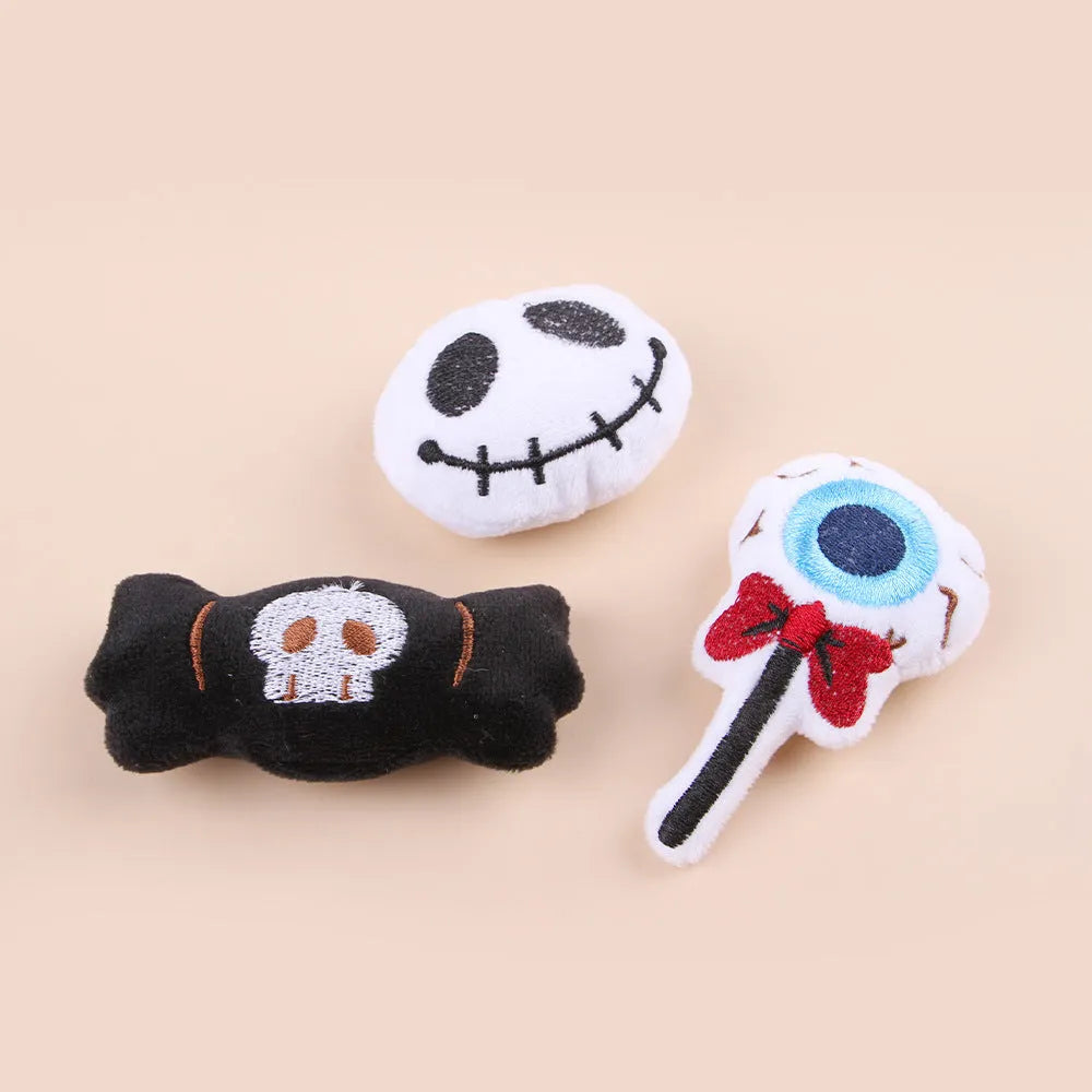 Plush cat teaser toy with three interchangeable heads: eyes, candy, and skull designs