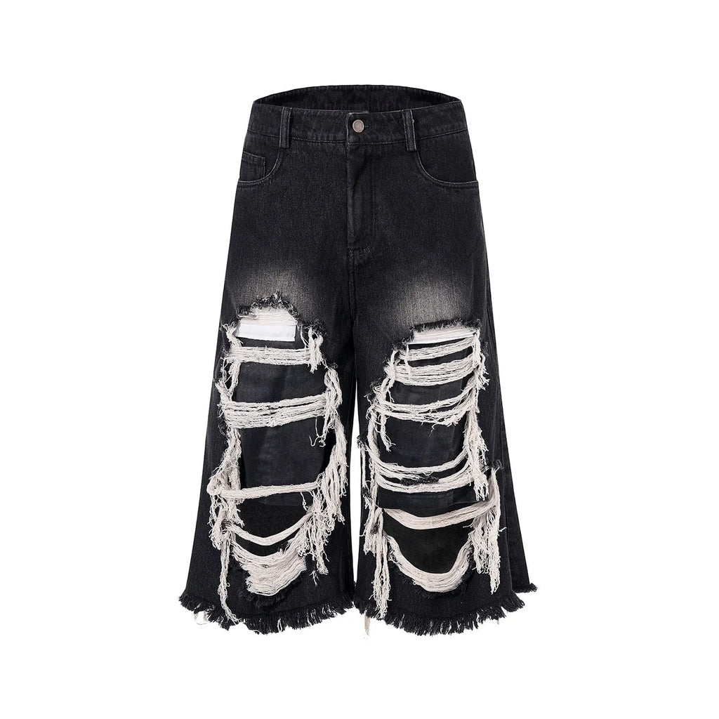 Black women's cropped wide leg jeans with distressed patches and a mid-high waist.