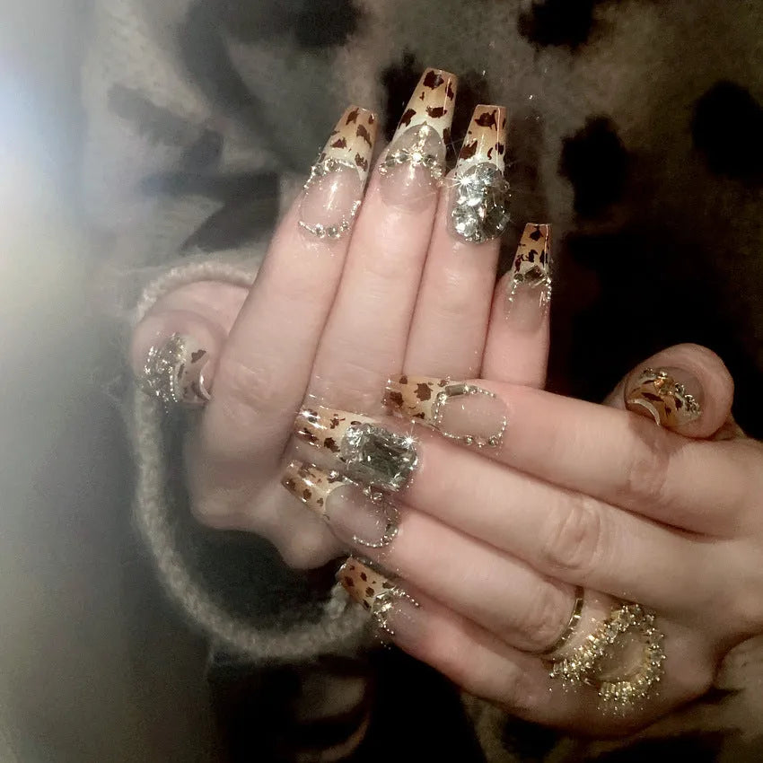 Leopard print plastic wearable nail armour set with advanced flash finish on women's hands