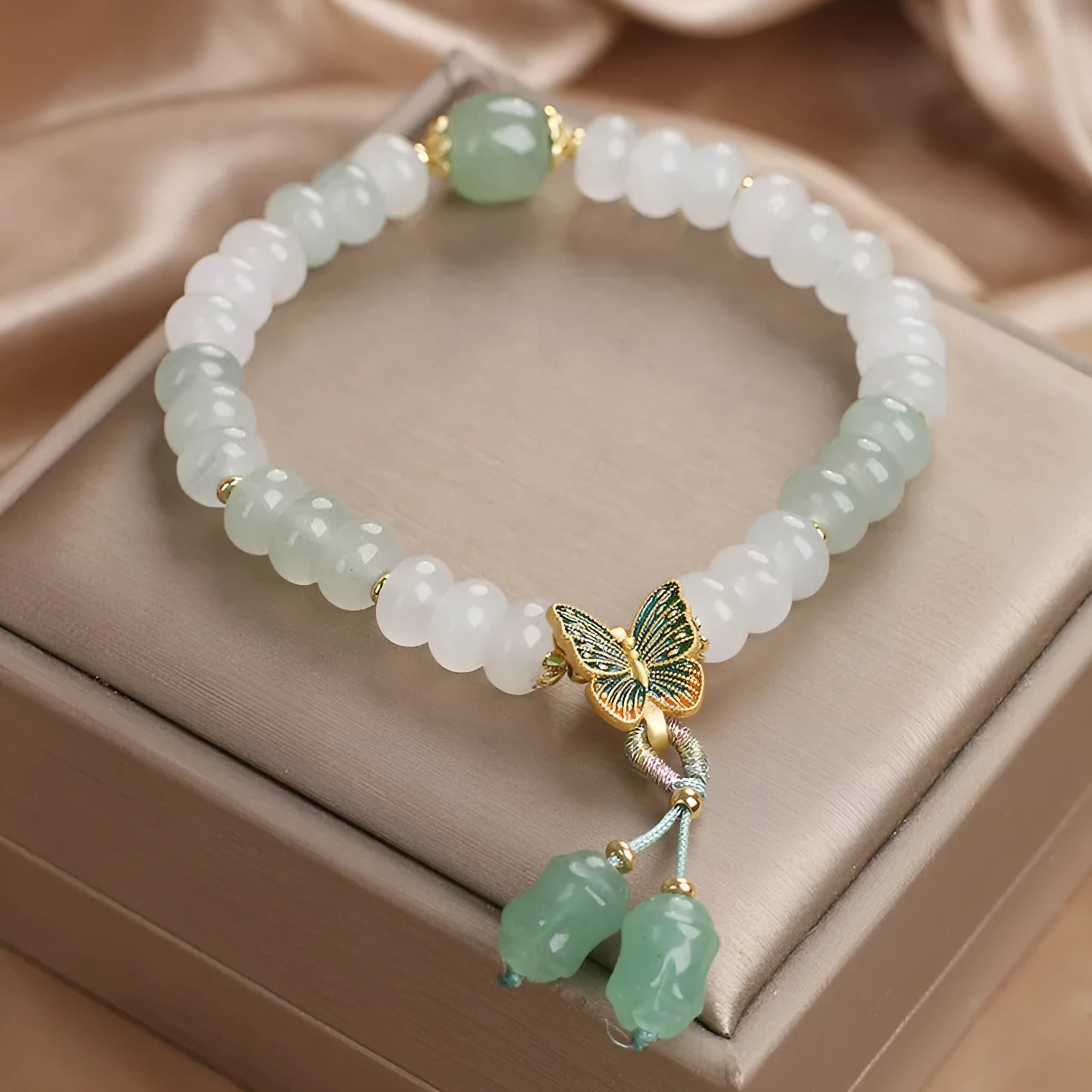 Green crystal women's bracelet with abacus beads, butterfly tassel, rhinestones and pearls