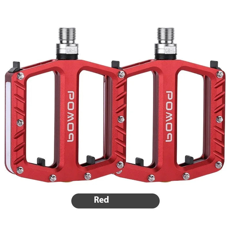 Bicycle pedals with LED lights in purple, black, titanium, red, and gold colour options
