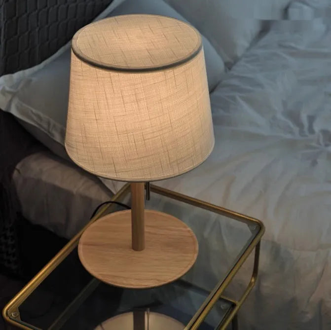 Walnut-coloured solid wood bedside lamp with fabric shade and cable switch