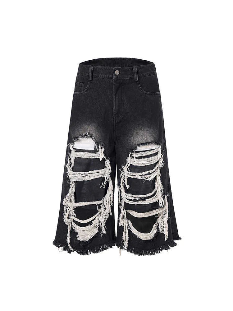 Black women's cropped wide leg jeans with distressed patches and a mid-high waist.