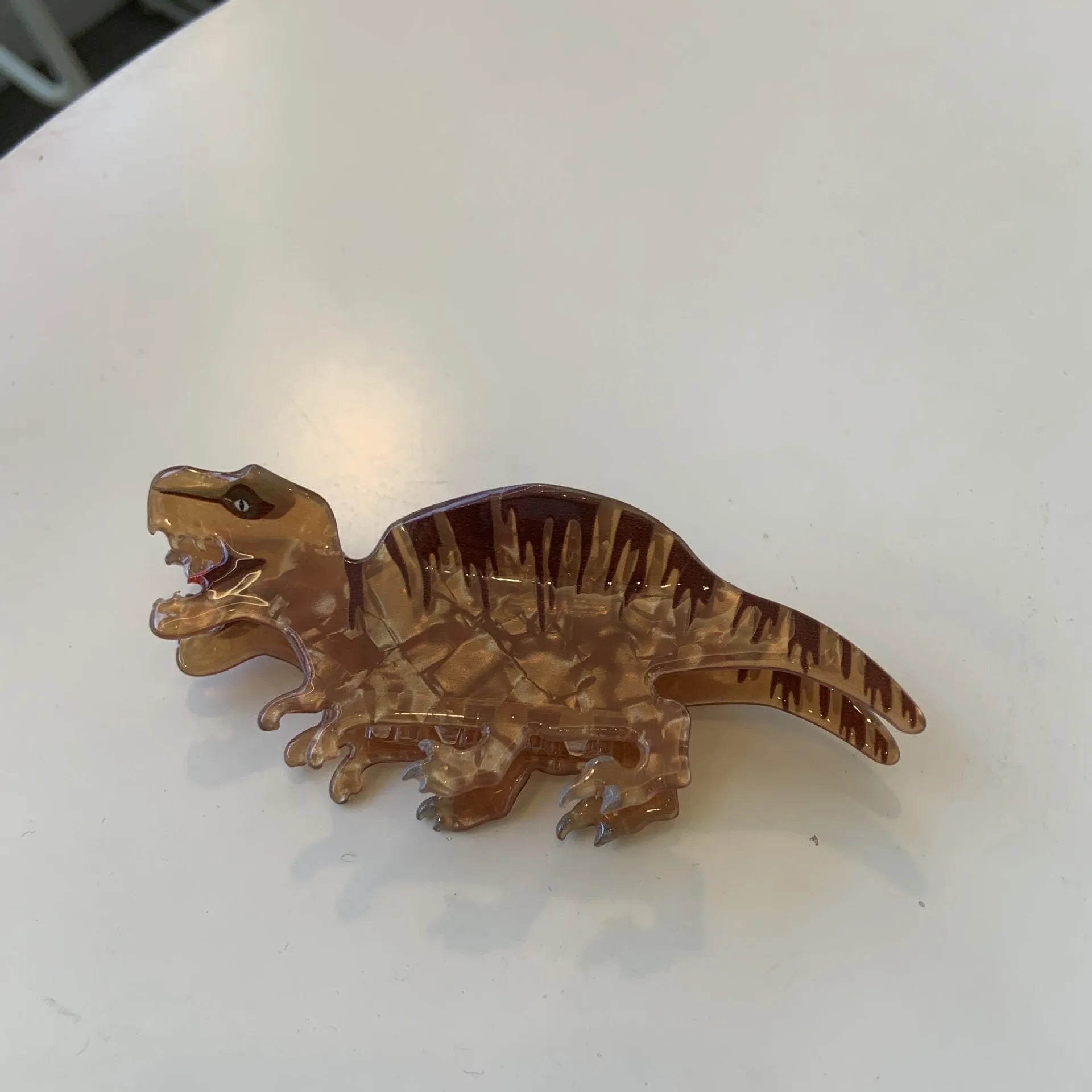 Dinosaur-themed acrylic jaw hair clip showing grip design with miniature dinosaur decoration