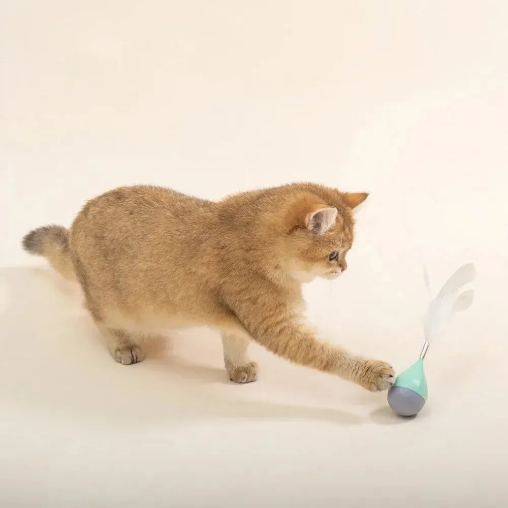 Feather Tumbler Cat Toy with goose feathers and aluminium alloy construction on pink background