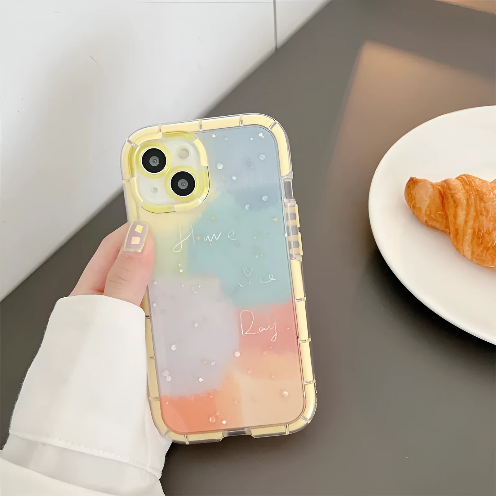 Minimalist iPhone 14 silicone case with a yellow edge on a dark background.