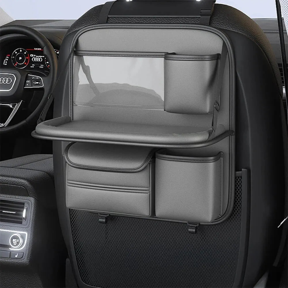 Car seat lazyback storage bag in Obsidian Black with foldable dining table extended, hanging on a car front seat backrest