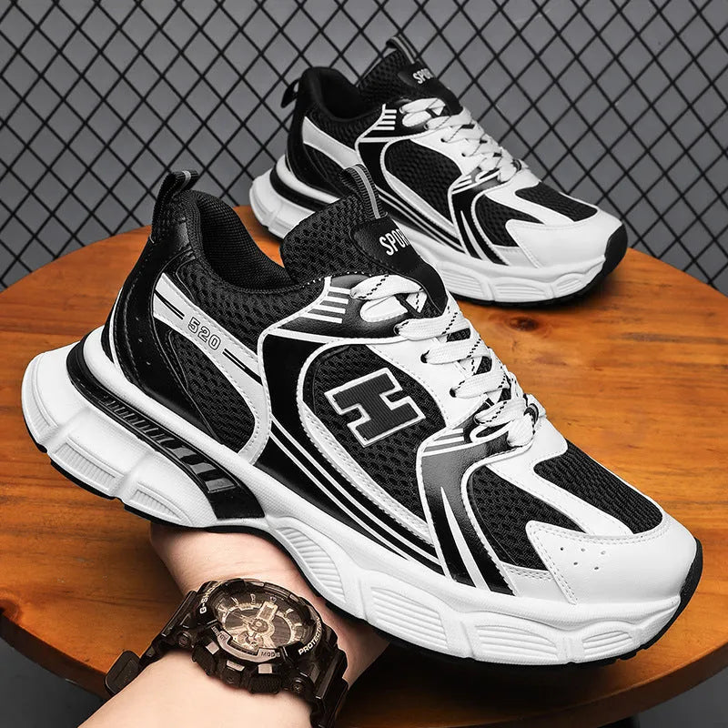 Men's white and grey mesh running shoes with a round toe and plastic sole on a plain background.