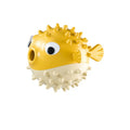 Green fish-shaped interactive dog toy with treat dispensing capability and raised surface particles