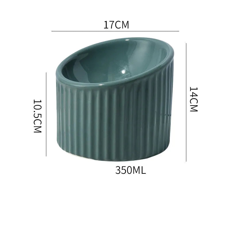 Elevated ceramic cat bowl in green, showing tilted design and raised height for feeding.