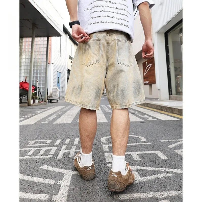Light blue men's denim shorts with ripped details and a straight-leg cut on a mid-rise waist.