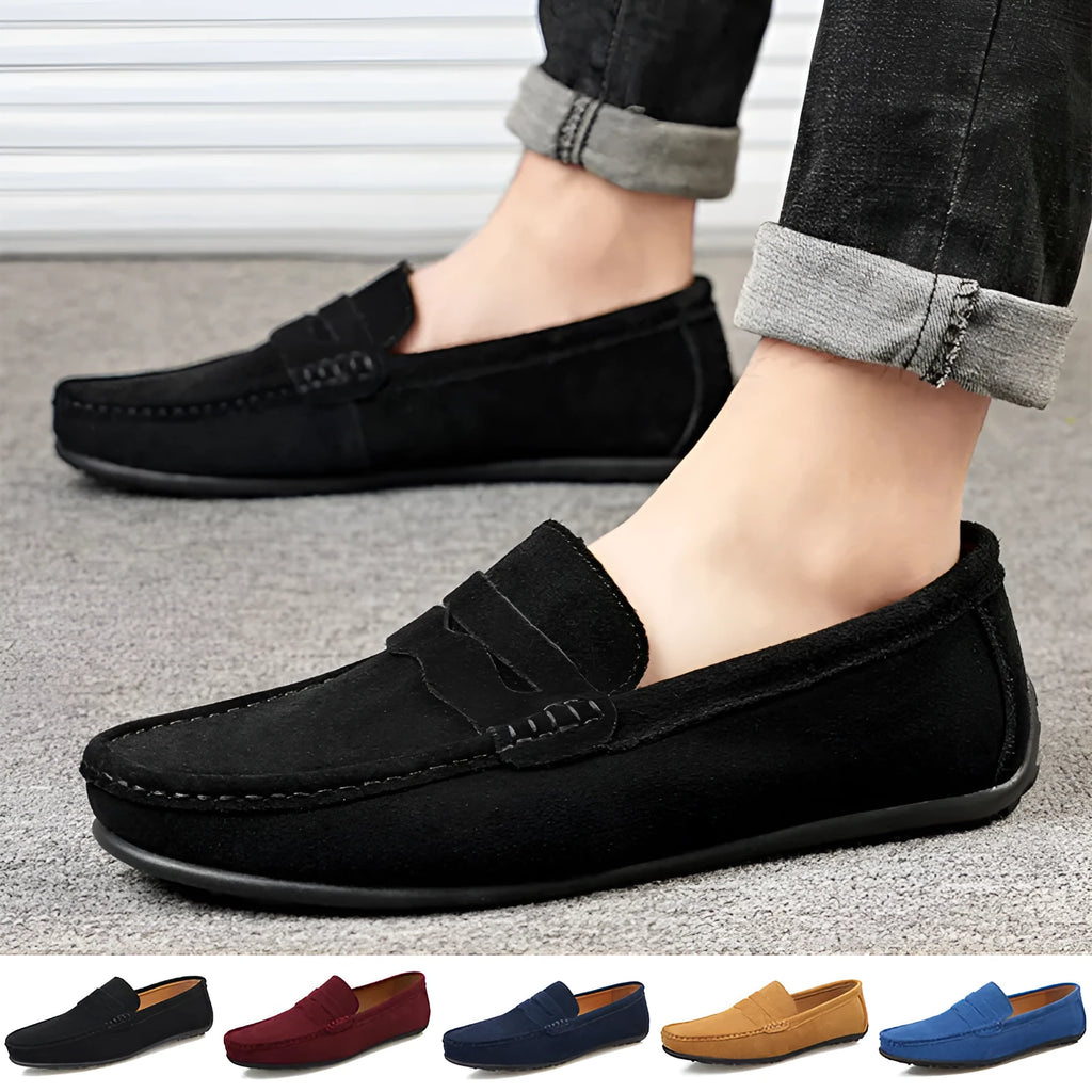 Men's solid colour suede loafers with round toe and rubber sole on a neutral background.
