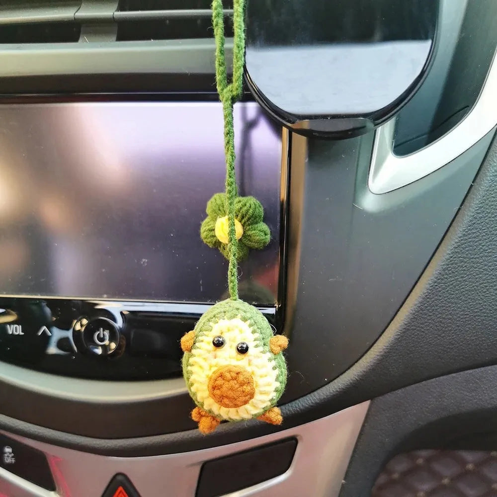 Handmade crocheted rainbow flower car pendant in wool with colourful avocado, pink, and red patterns