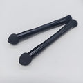 Double-headed black makeup brush with a pointed concealer brush on one end and an angled sponge on the other.