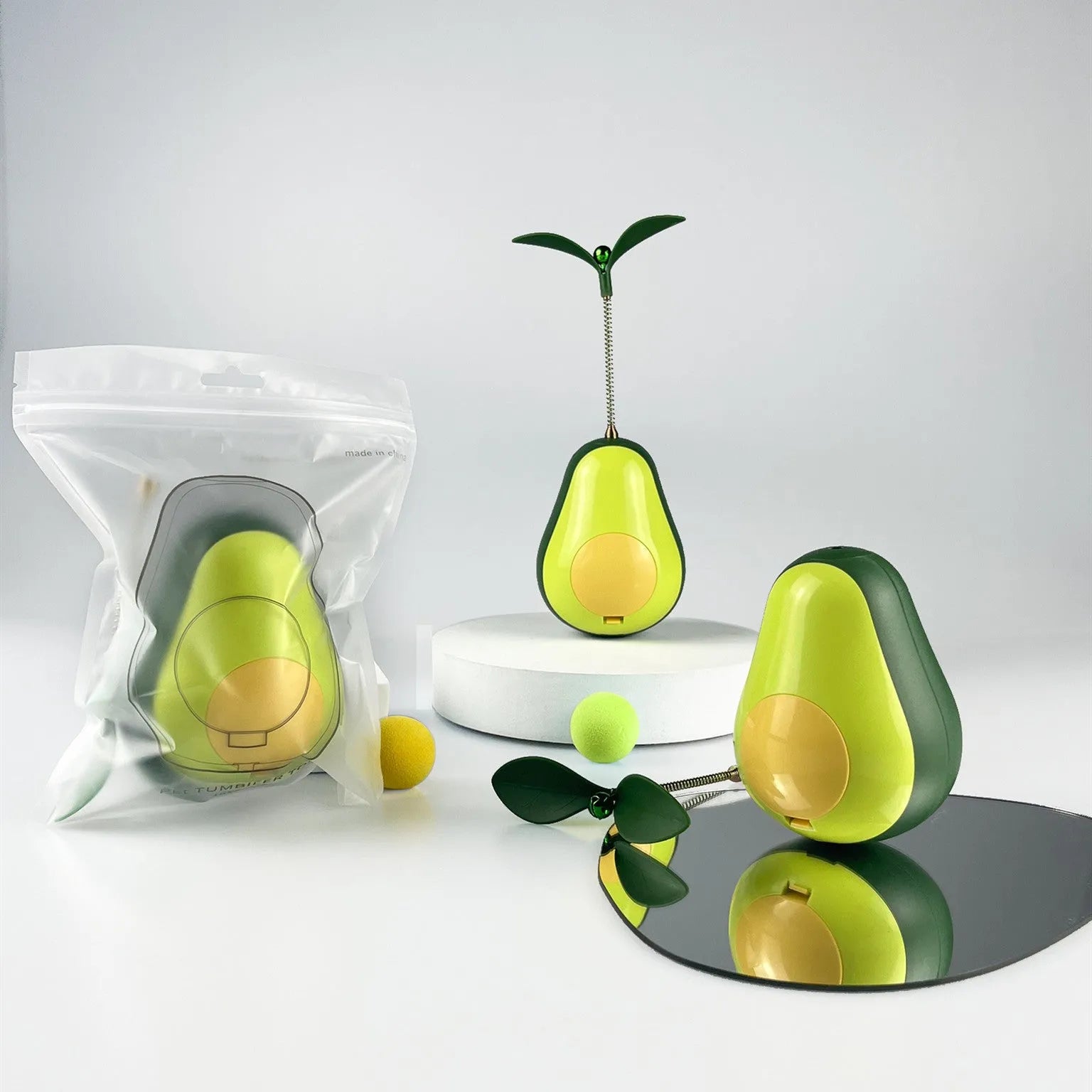 Green silicone avocado-shaped cat toy tumbler with treat dispensing opening, 80x80x107mm size