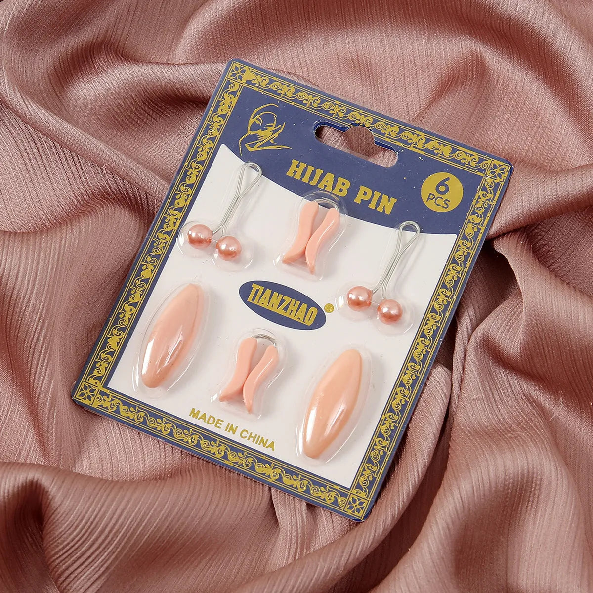 Plastic scarf clip with oval meander pattern and resin drip finish in five colours including black, gray, white, brown, and pink.