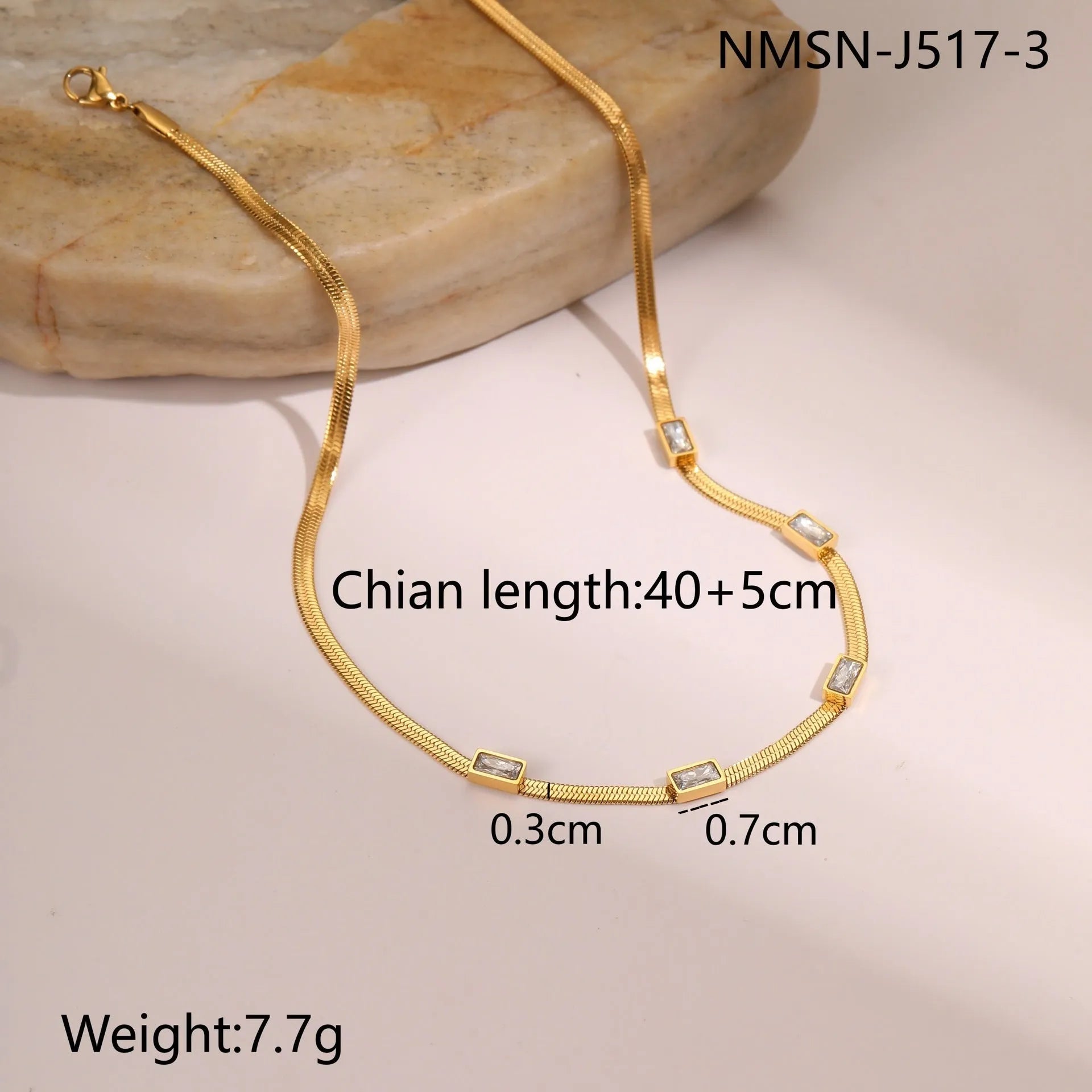 Geometric square zircon pendant on a flat stainless steel snake chain necklace in a gold colour finish.