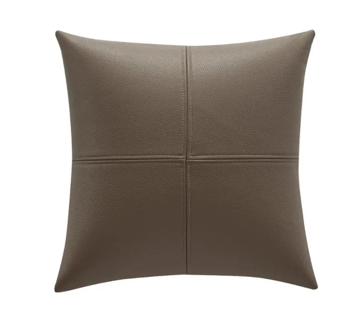 Soft cowhide leather pillow cover in a solid colour on a sofa.